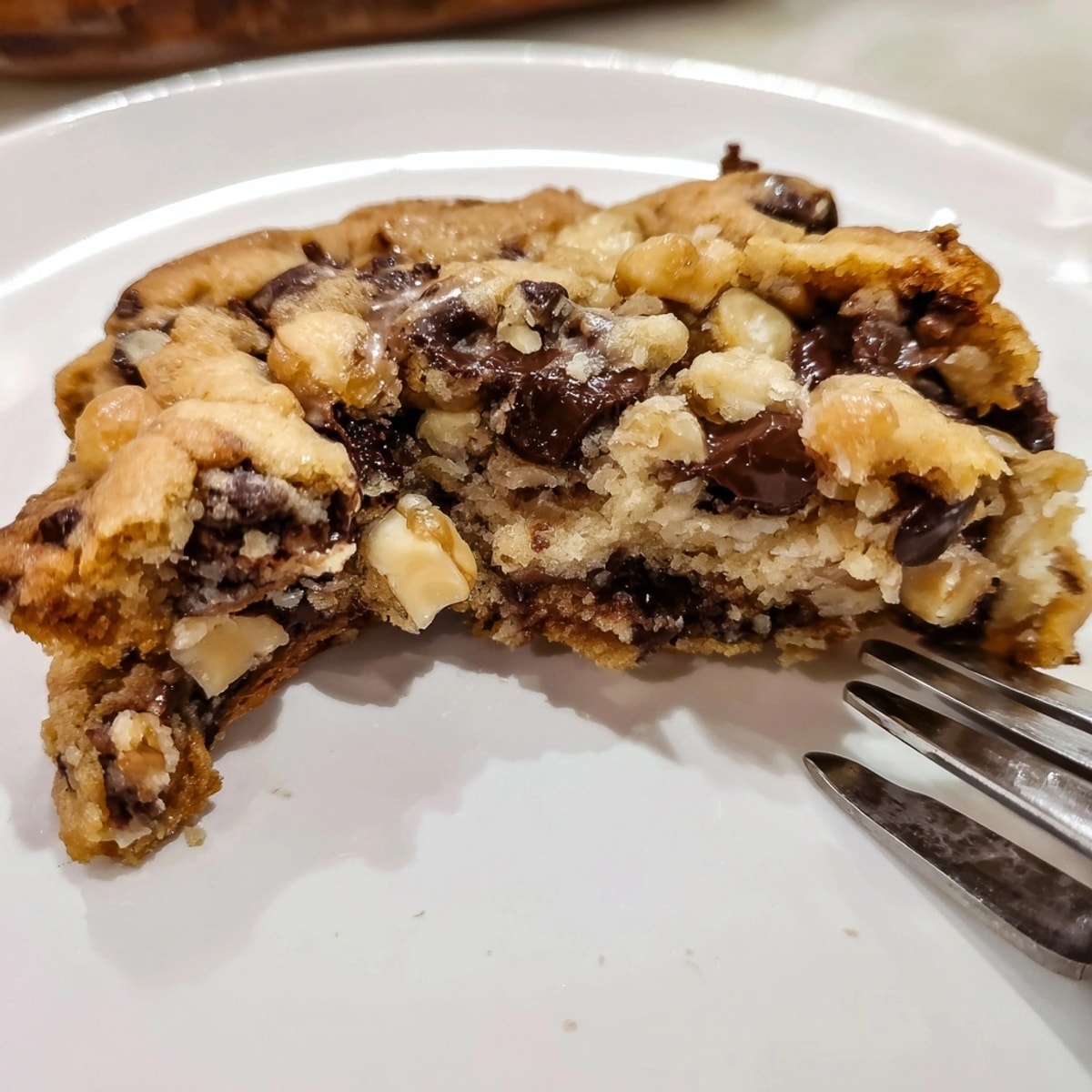 Close-up of a decadent Thick Bakery-Style Cookie, showcasing its gooey center and crisp edges.