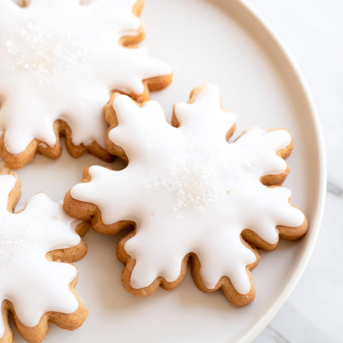 Warm, golden Winter Market Brown Sugar Snow Sugar Cookies iced with glistening white frosting, ready to enjoy.