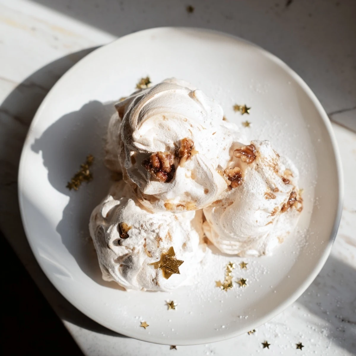 Golden-brown toasted walnuts folded into delicate Winter Market Brown Sugar Snow meringue, served on a cozy platter beside steaming mugs of hot cocoa.