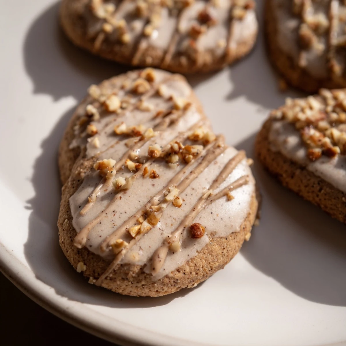 Winter Spice Hazelnut Drizzle Sugar Cookies arranged on a rustic platter, their golden edges glistening with a nutty, sweet drizzle.