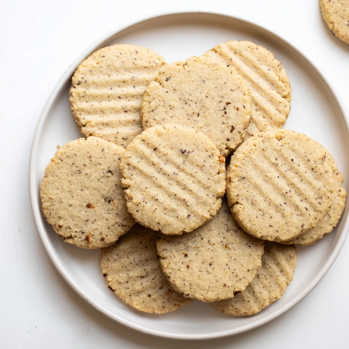 Golden brown keto vanilla chai spiced cookies cooling on a wire rack with soft centers