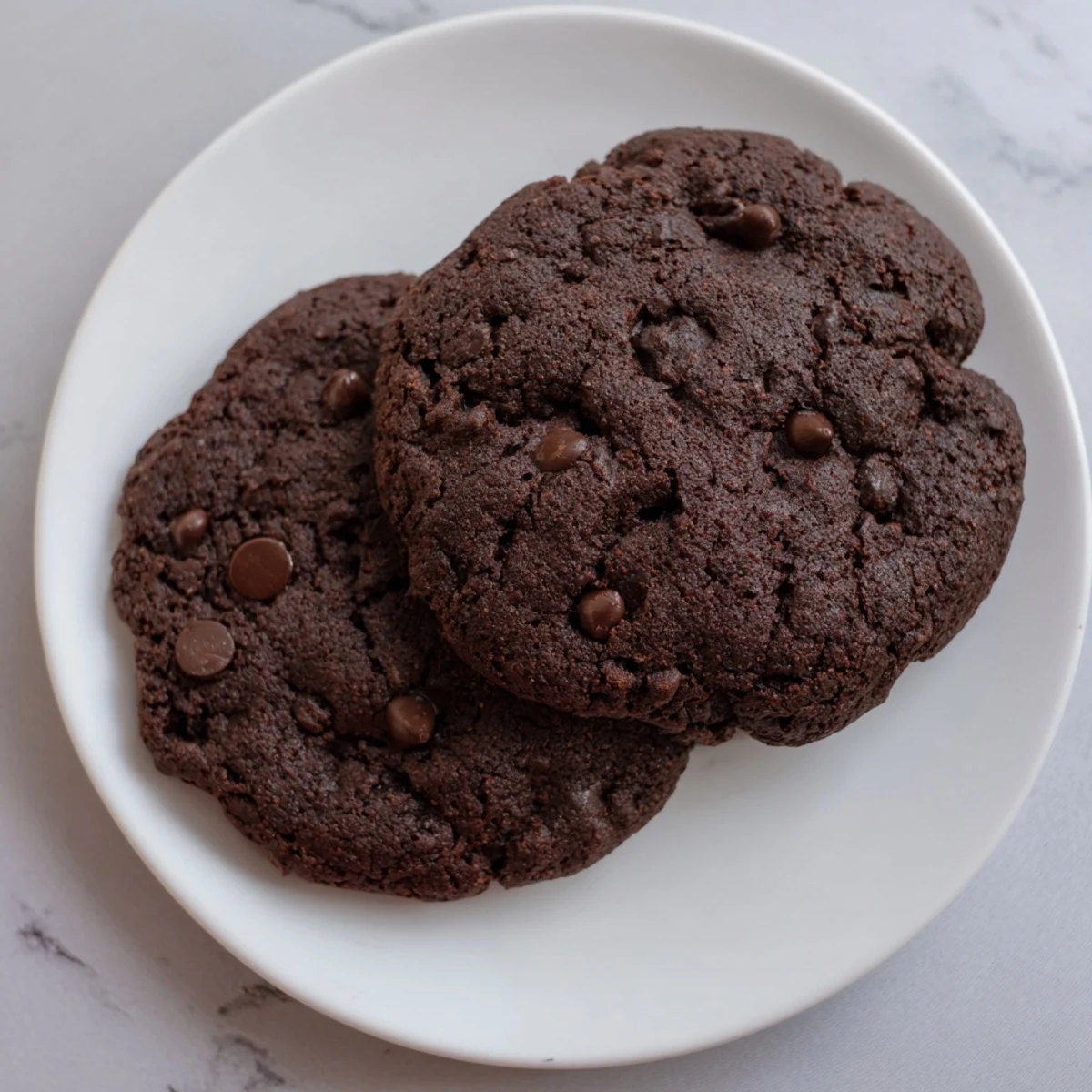 Close-up of gluten-free double chocolate chip cookies showing rich cocoa dough studded with semi-sweet and milk chocolate chips