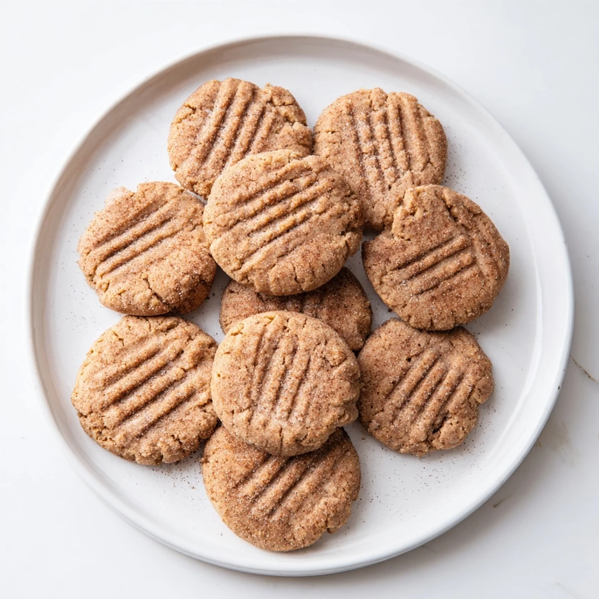 Soft chewy keto cinnamon almond butter cookies sprinkled with sweet cinnamon sugar topping