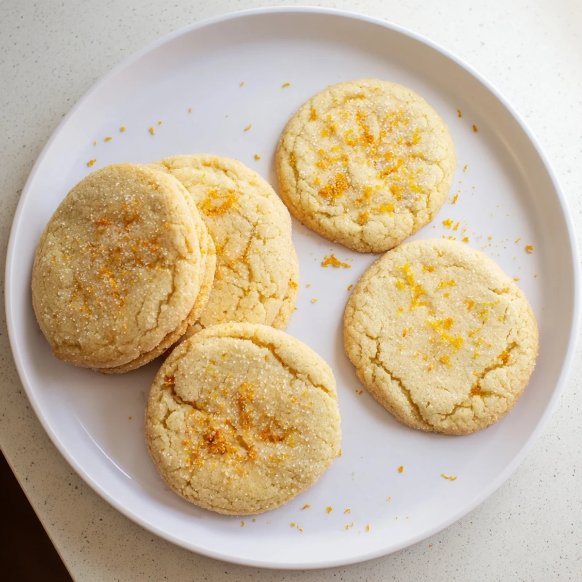 Homemade vegan sugar cookies topped with crunchy sugar crystals and fresh citrus zest
