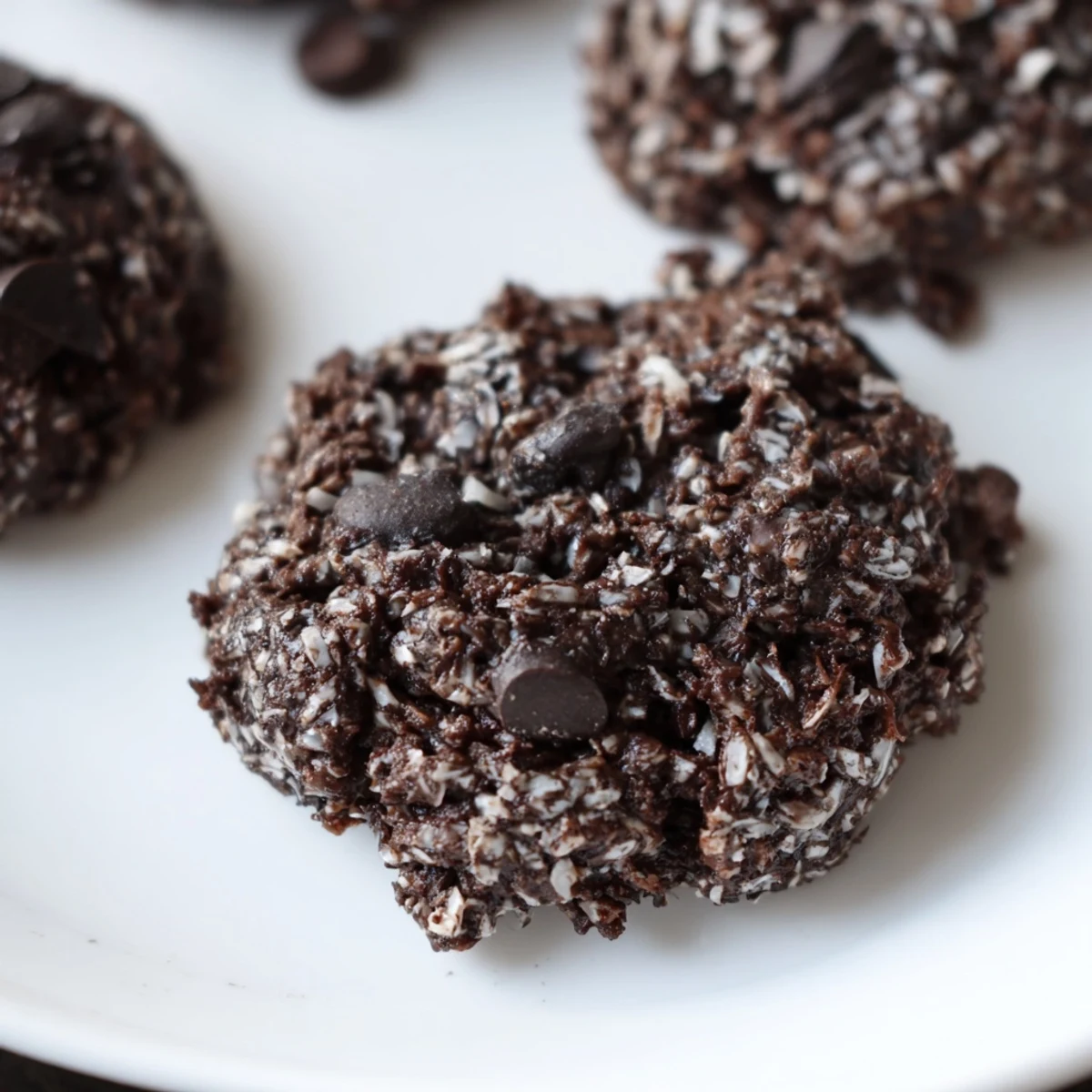Freshly baked sugar-free keto mocha coconut cookies cooling on a wire rack with dark edges