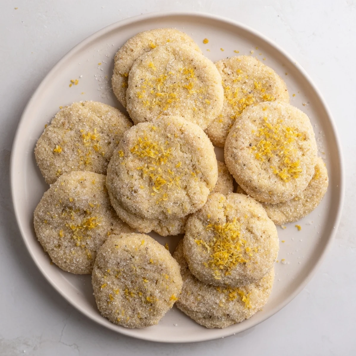 Golden plant-based grapefruit vanilla sugar cookies cooling on wire rack with citrus zest garnish