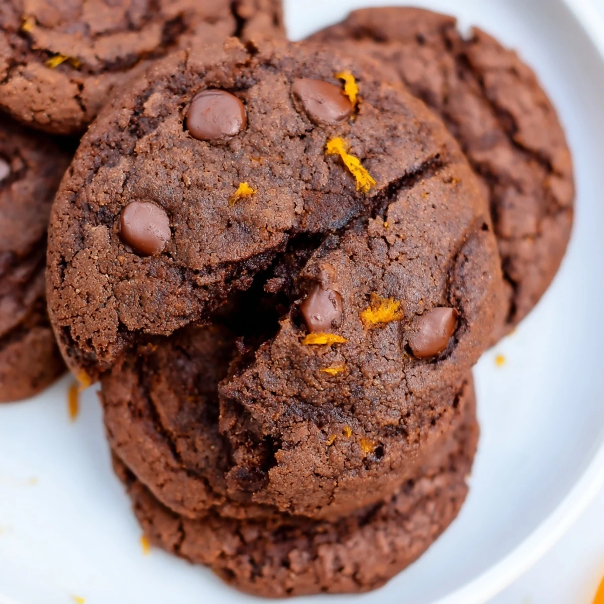 Freshly baked gluten-free double chocolate orange cookies showing soft centers and chocolate chunks