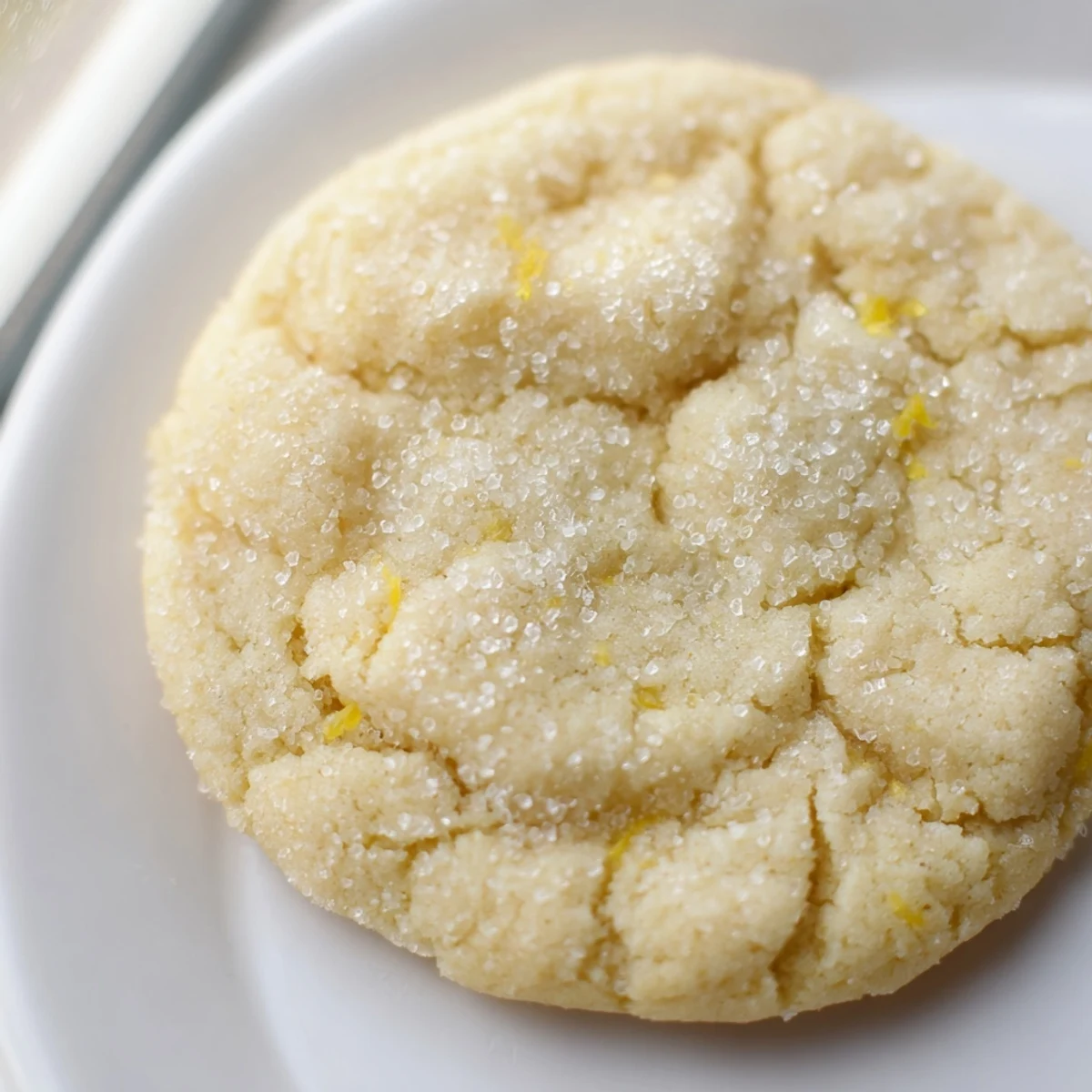 Chewy plant-based yuzu sugar cookies dusted with sparkling sugar and bright citrus zest