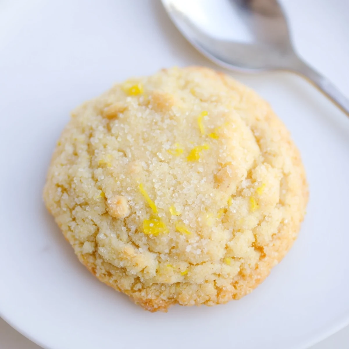 Gluten-Free Lemon Almond Sugar Cookies piled on parchment, zesty, lightly golden edges