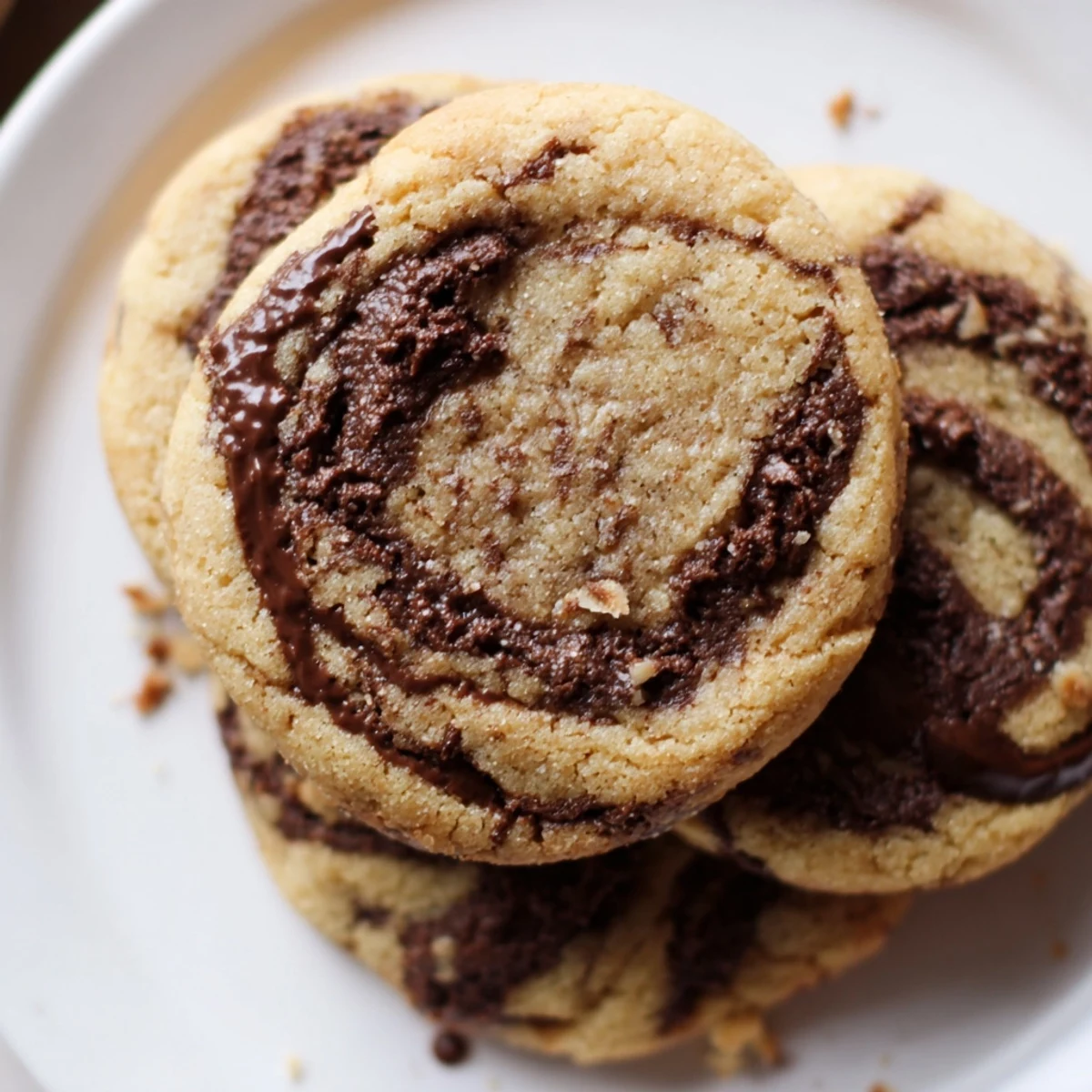 Stacked on a dessert platter, Gluten-Free Espresso Chocolate Swirl Cookies show fudgy swirls.
