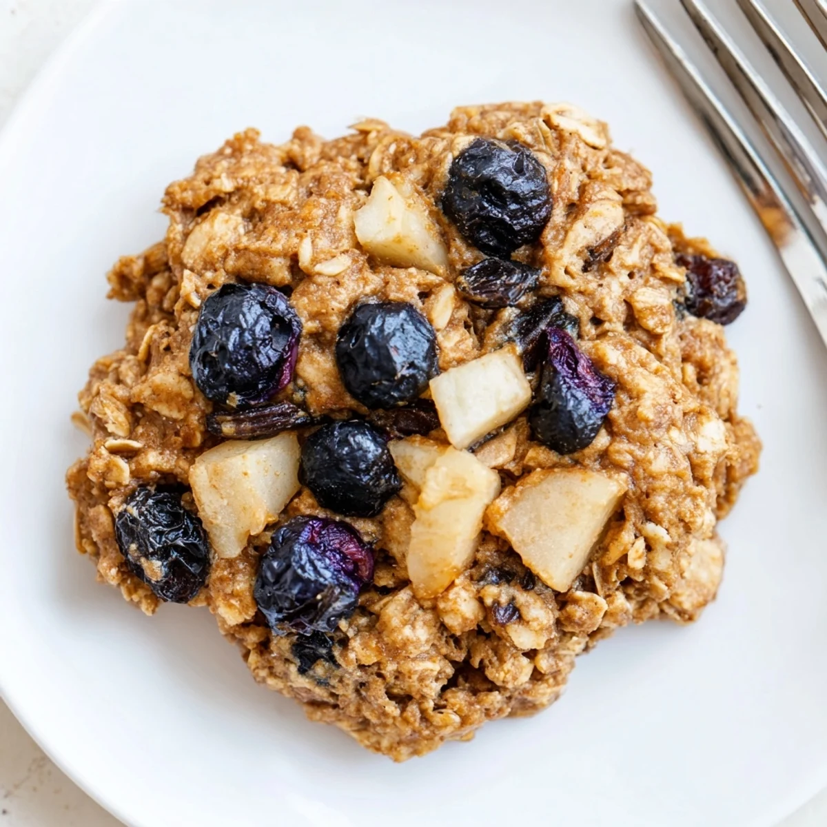 Stack of Vegan Blueberry Apple Oatmeal Raisin Cookies served with almond milk