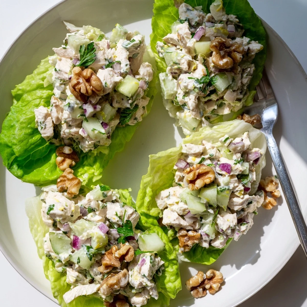 Golden diced chicken folded into cottage cheese yogurt mixture inside butter lettuce boats