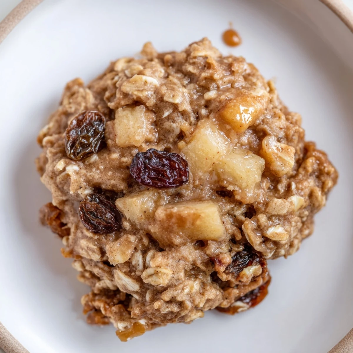 Chewy Apple Maple Oatmeal Raisin Cookies stacked beside a steaming mug