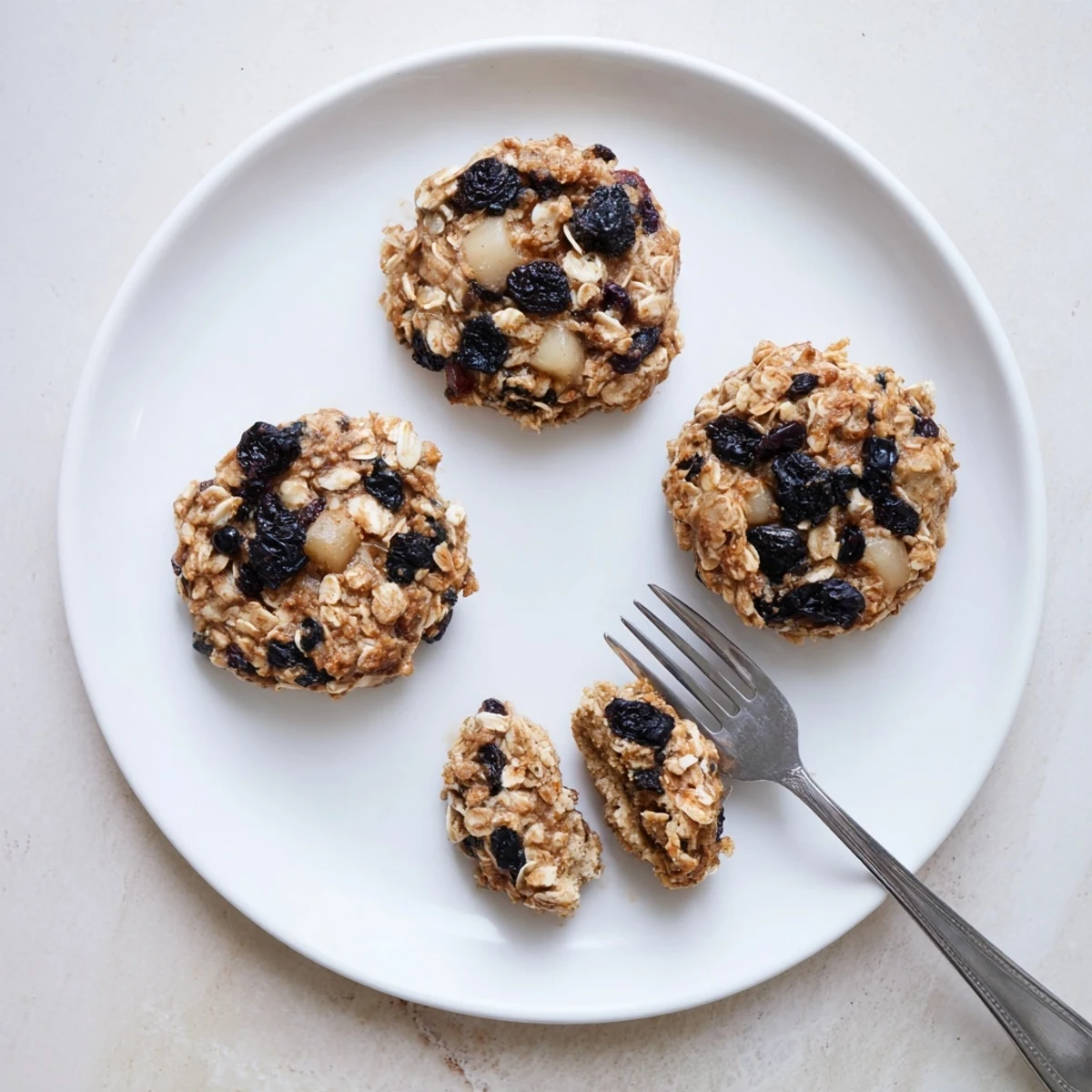 Tray of golden Vegan Blueberry Pear Oatmeal Raisin Cookies sprinkled with cinnamon.