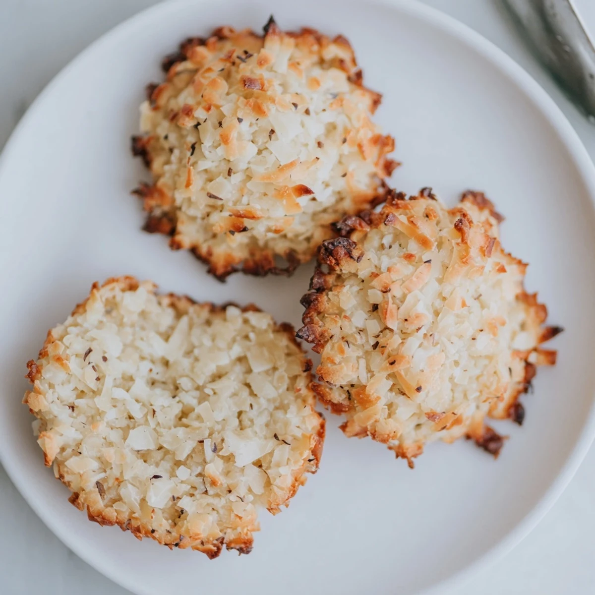 Stack of Keto Vanilla Coconut Crisp Cookies beside tea, crisp low carb treat