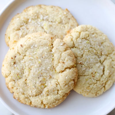 Chewy vegan coconut lime sugar cookies dusted with shredded coconut and sparkling sugar crystals