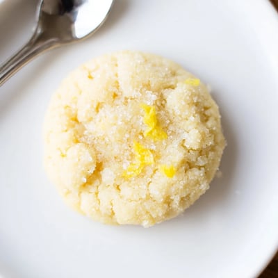 Warm Gluten-Free Lemon Almond Sugar Cookies cooling on rack, sugared sparkle