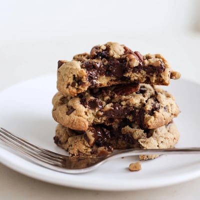 Crisp gluten-free espresso chocolate pecan butter crunch cookies on a cooling rack after baking  